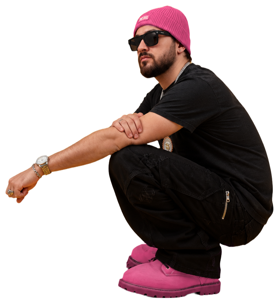Pink92 crouching on the snow in a pink beanie, black outfit and pink boots